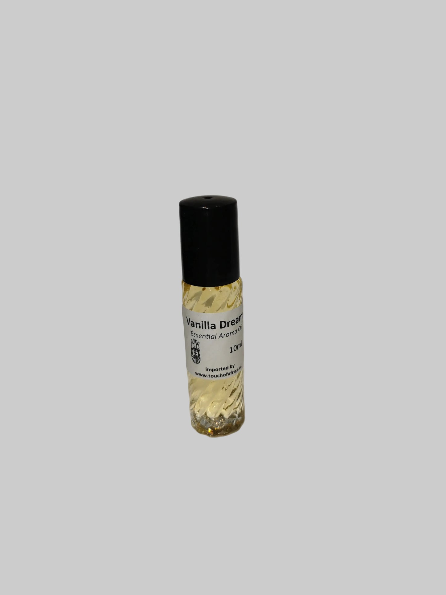 Small bottle of Vanilla Dreams essential oil on a white surface with a white background